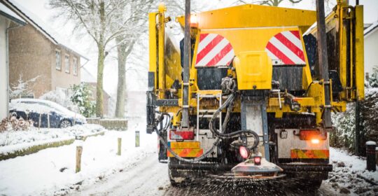 Winter road maintenance truck spreading salt